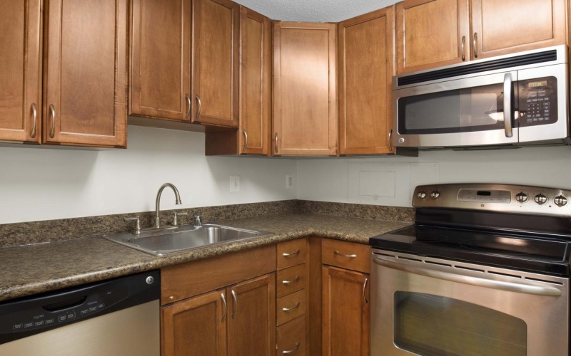 a kitchen with wooden cabinets