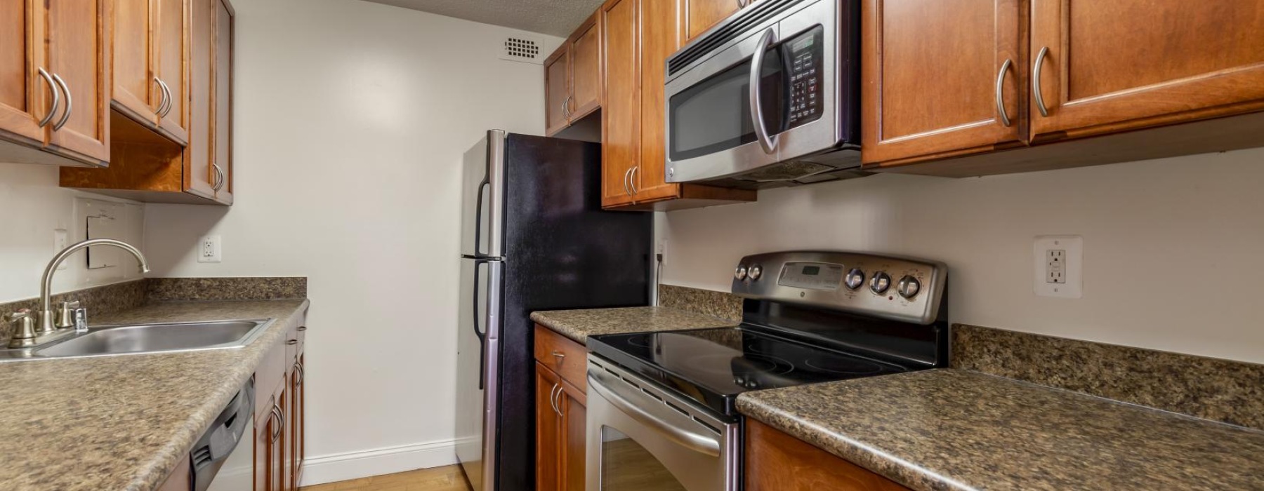 a kitchen with wooden cabinets