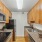 Kitchen with dark cabinetry and stainless steel appliances