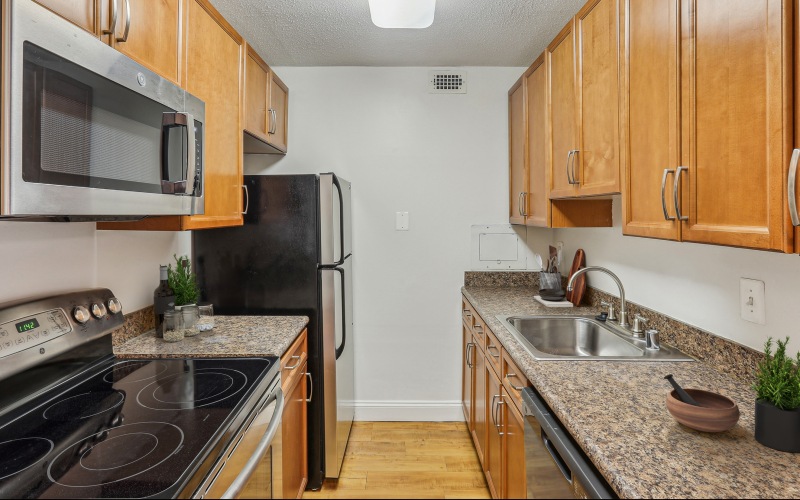 Kitchen with dark cabinetry and stainless steel appliances