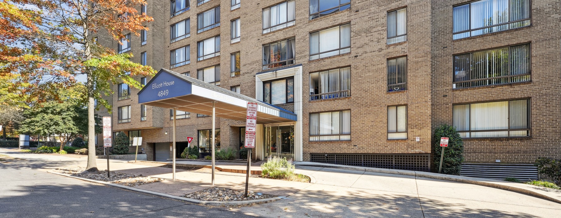 Building exterior with trees and street