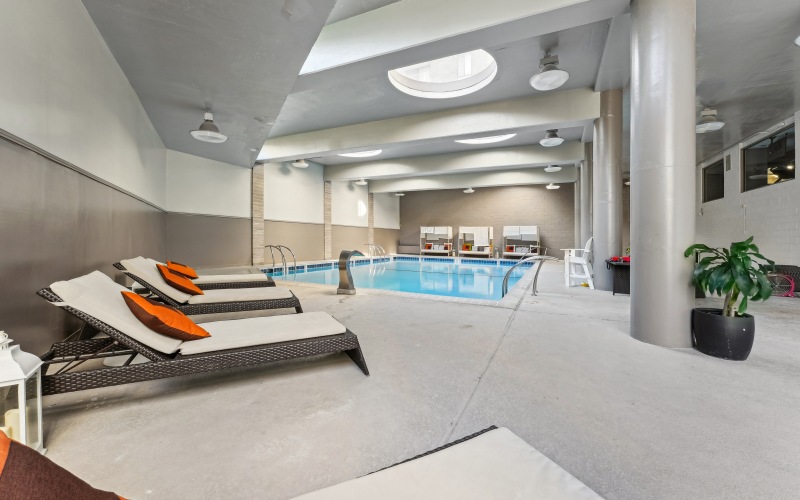 Indoor pool with lounge seating 